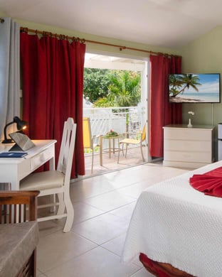 Beachfront room in Negril with king bed, rain shower, minibar, in-room safe, and balcony.